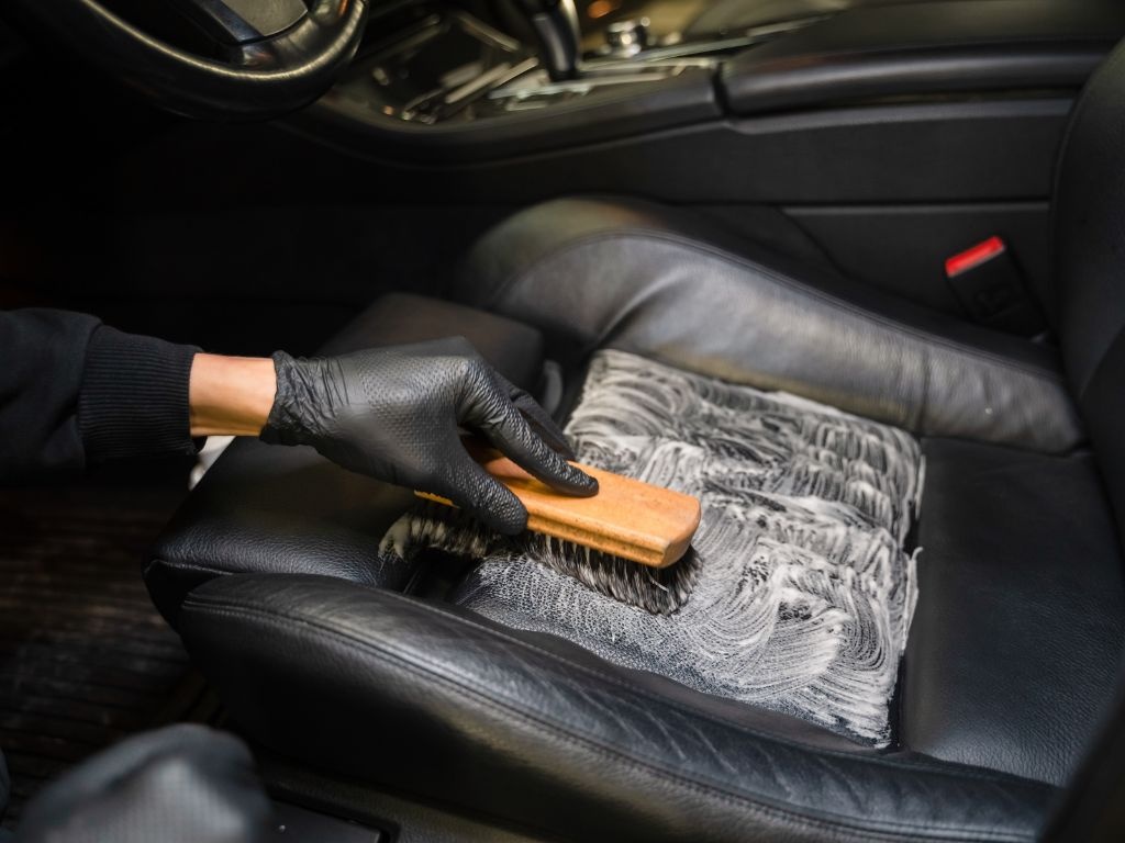 Professional interior car detailing of leather seats and dashboard